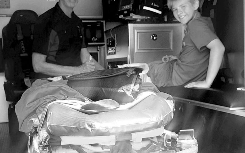 Volunteer emergency responder, Rob Boll showing the ambulance to nephew, Ethan Boll. Photo by Christine Jensen.