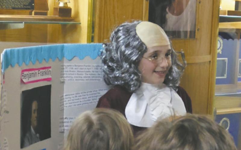 Fifth grader Austyn Stangeland shared her presentation on founding father Benjamin Franklin with a group from the first grade class. Photo by Jamie Rarick