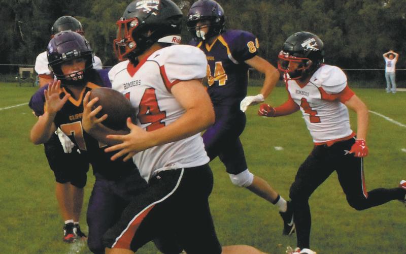 Fighting off the Clipper defense, Praise Chairez carries the ball for a Bomber touchdown. Photo by Jamie Rarick
