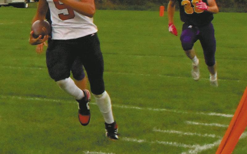 Mason Pollestad sprints down the sideline for a successful touchdown drive. Photo by Jamie Rarick