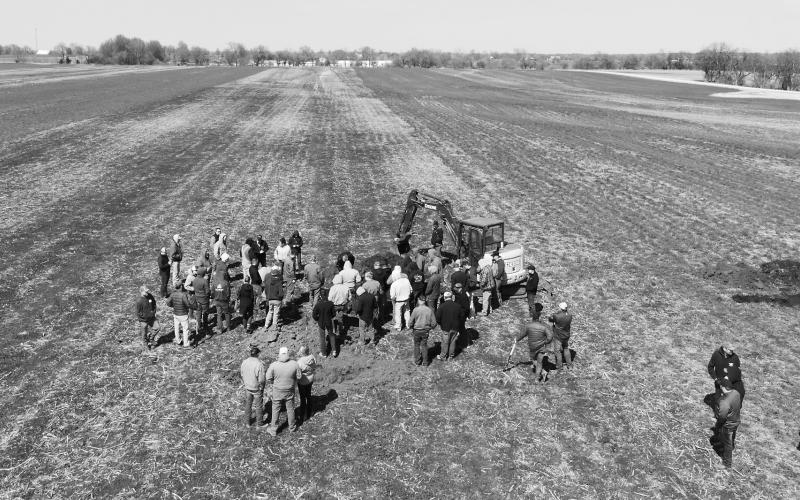 Farmers view a soil pit as part of an on-farm soil health research project. NDSU photo.