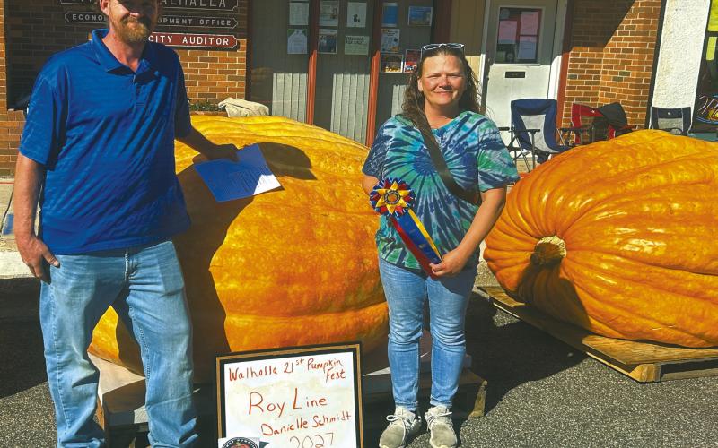 Roy Line and Danielle Schmidt of Grafton with their record-setting pumpkin. Photo by Robert Ripple.