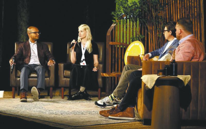 Suhas Narayanaswamy of Lewis and Clark AgriFood (left) in discussion with moderator Jennifer Marston of Ag Funder at a panel on innovations that will impact agribusiness in the future hosted by Bushel in Fargo in June. Patrick Honcoop (right), CEO of Ag-Tech Pro, and Jake Joraanstad (far right) listen in.
