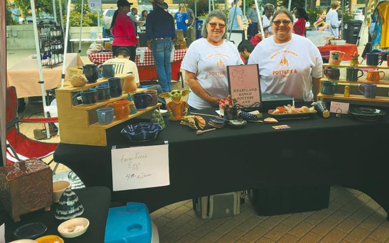 Elizabeth Linster and her sister, Sherry selling Heartland Ranch Pottery at a street fair. Submitted photo.