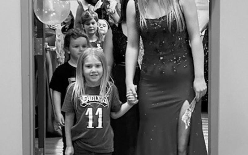 Young ladies from North Border School were escorted by Mrs. Longtin’s kindergarten class to show off their dresses at PNC prom. Submitted photo.