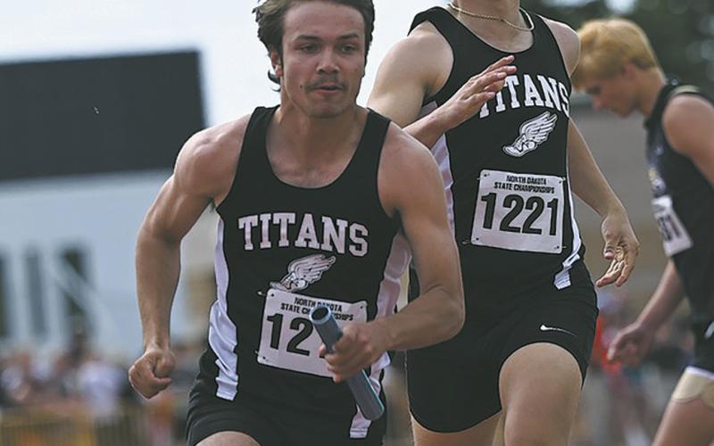 Trenten Bronson-Keena took off once he had the baton from Carter Johnson during the 4X100 relay. Photo by Ashley Schafer