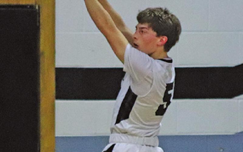 Sam Johnson puts up a three early in the game against the Larimore Polar Bears. VNV Photo by Lesa Van Camp