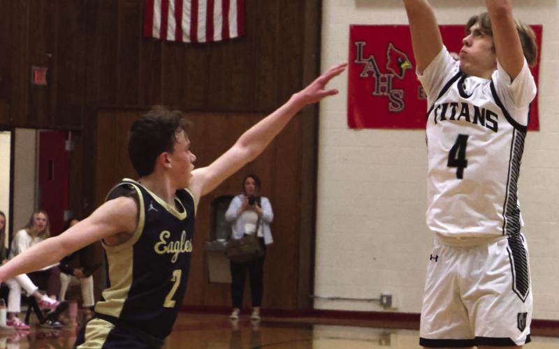 Charles Kittelson shoots over North Border’s Kaden Moore.