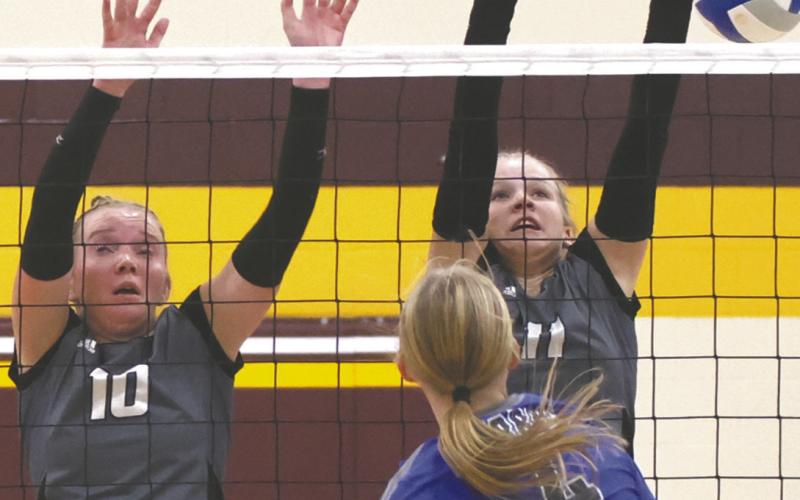Easton Larson and Violet Hoyles block a H-VC kill attempt. Photo by Lyle Van Camp