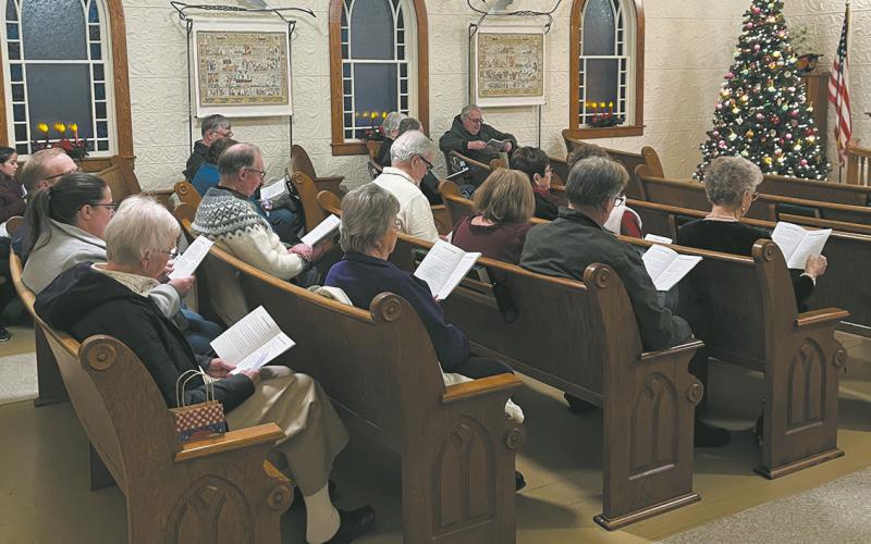 Attendees filled the pews last year for the Carol Sing at the beautifully decorated Hallson Church.
