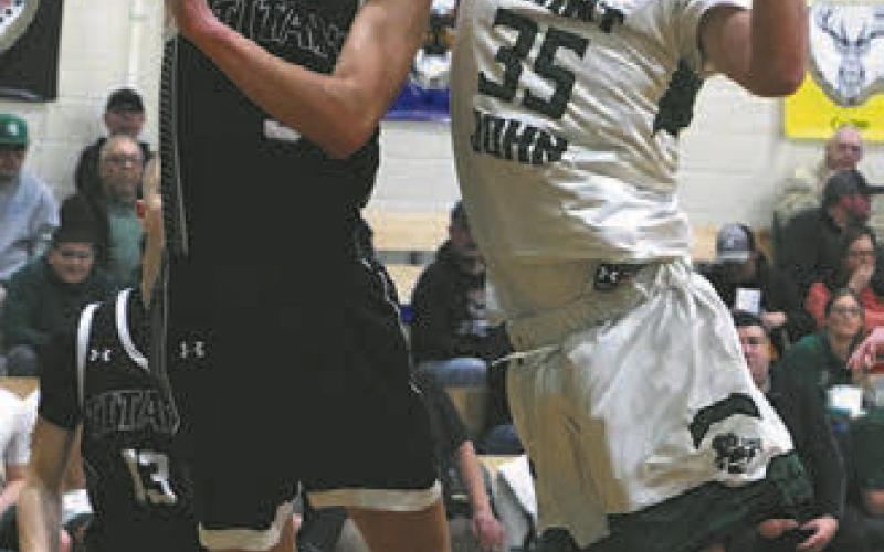 Jayse Gullickson shoots past St.John's Simon LaRocque.