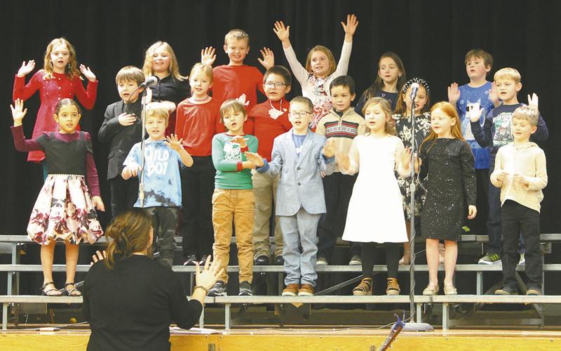 Grades one and two included some fun actions during singing at the winter program on Friday morning. Photo by Jamie Rarick