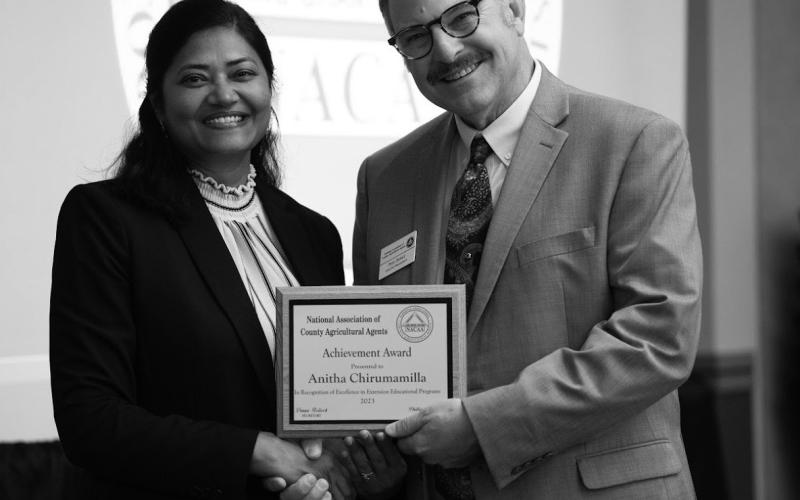Anitha Chirumamilla, Extension cropping systems specialist at the NDSU Langdon Research Extension Center, receives the National Achievement Award at the National Association of County Agricultural Agents conference. (NDSU photo)