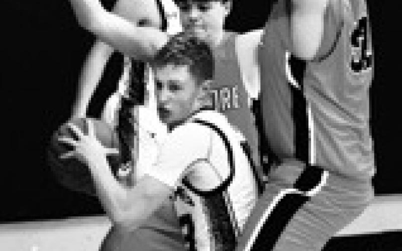 Connor Hurtt looks for an open teammate in action against Larimore. Photo by Lyle Van Camp.