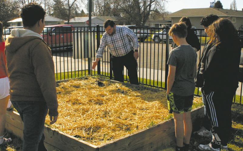 Mr. Riddle, leading a lesson in agriculture with the seventh graders at DPS community garden. Photo by Jamie Rarick