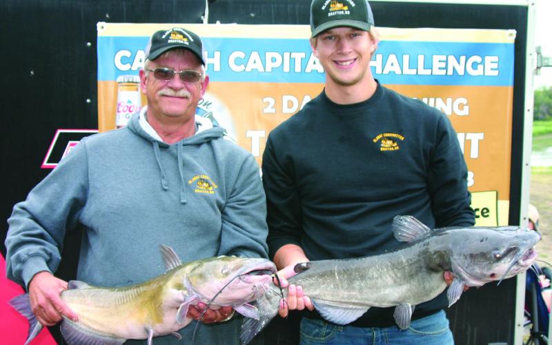 Jeff and Thomas Blawat of Drayton pose with their catches of the day. Photo by Rob Boll.
