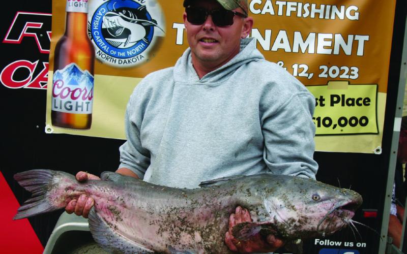 Chris Dolan poses with the second biggest fish caught in the tournament at 24 pounds. Photo by Rob Boll.
