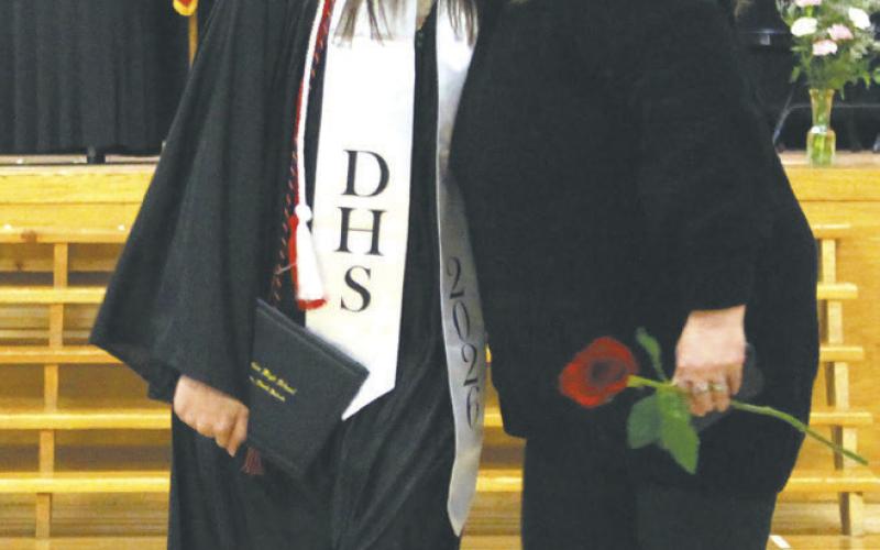 New graduate Justyce Wallery gets kissed on the cheek leaving the commencement ceremony. Photo by Andrea Johnston