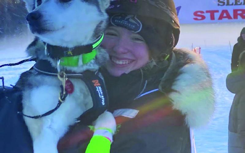 Robinson poses for a photo with one of her diva dogs upon completion of the Junior Iditarod.