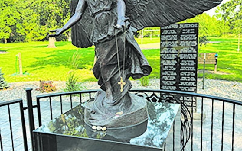 The Angel of Hope monument in Leistikow Park is adorned with memorial trinkets left by loved ones. Photo by Andrea Johnston