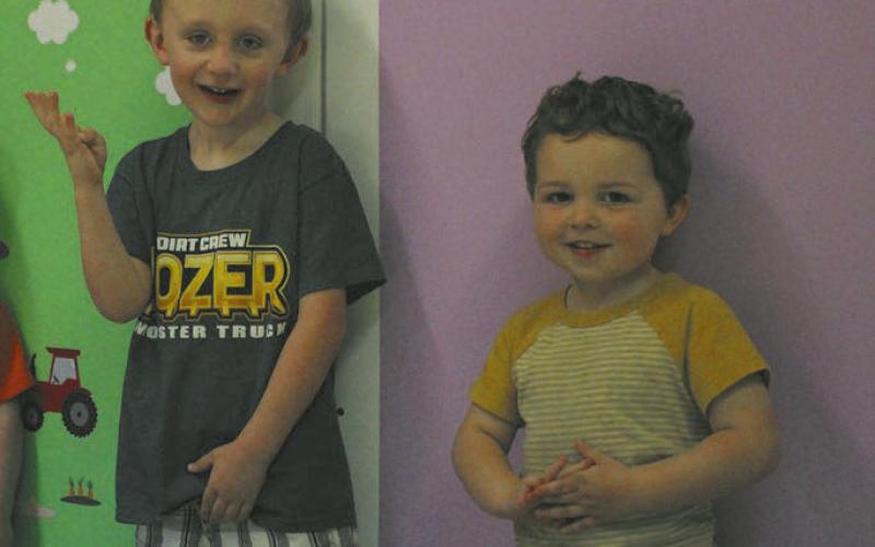 Children at the daycare were eager to have their pictures taken. Photo by Andrea Johnston