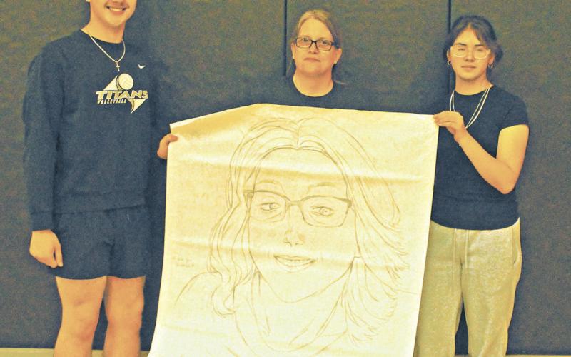 Maddox Oihus and Allisson Chavez represented the junior class for the drawing contest during Friday's spirit week activities. They won with their portrait of Drayton School Secretary Denise Cole. Photo by Jamie Rarick.