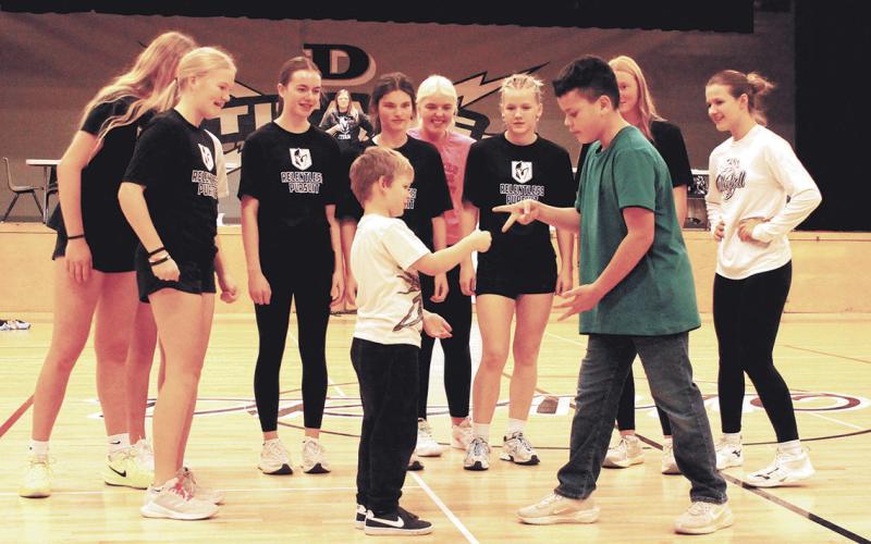 In a championship showdown, kindergartener Pearce took on sixth grader Noah in 'Rock, Paper, Scissors' and won in front of a cheering crowd. Photo by Jamie Rarick.