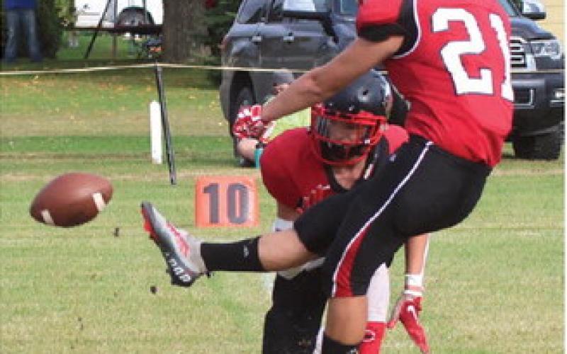 Hunter Johnson kicks for the two points after a Bombers touchdown against New Town Saturday. All photos by Lyle Van Camp