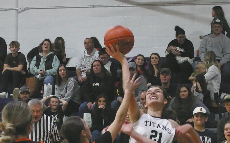 Facing heavy defense, senior Elizabeth Fedje puts up the shot. Photo by Jamie Rarick