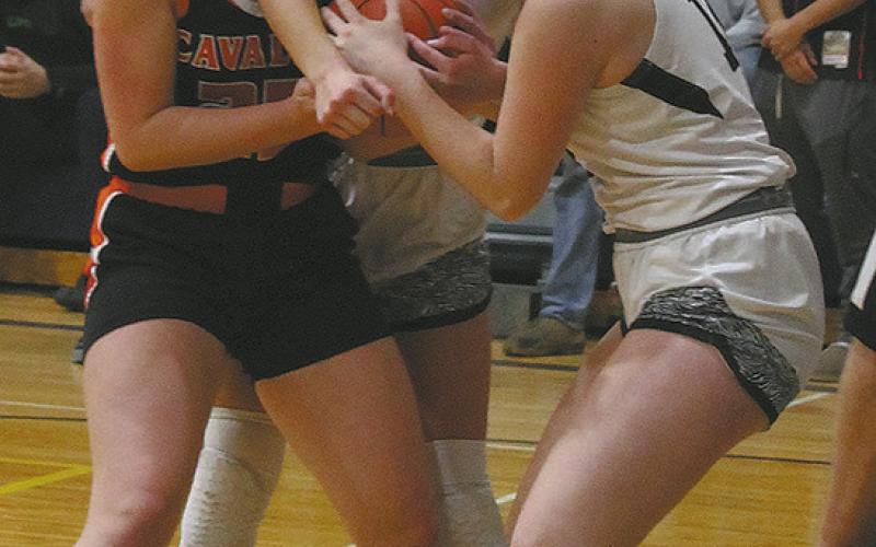 Cavalier's Katy Jensen fights for control of the ball against DVE's Jaelyn Johnson and Ingrid Myrdal. Photo by Jamie Rarick