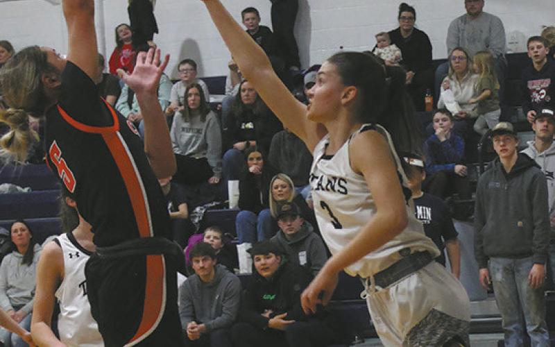 Cavalier's Emma Seng goes for the shot against DVE's Rosalyn Fedje. Photo by Jamie Rarick