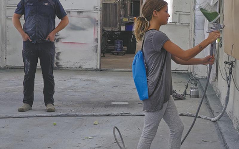 Although they weren’t using actual paint, students visiting CVR Industries in Neche were given the chance to operate the equipment in the paint room. Submitted photo