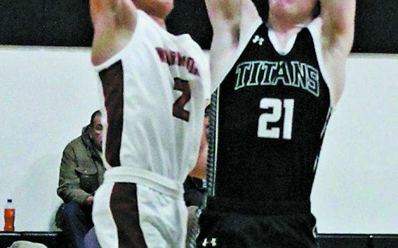 Carter Oberg goes for the shot past Warrior defender Monty Redfox, Jr. Photo by Jamie Rarick.