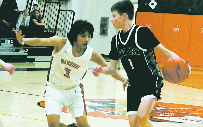 Drew Passa looks to move the ball past Warrior defender Aiden Black. Photo by Jamie Rarick.