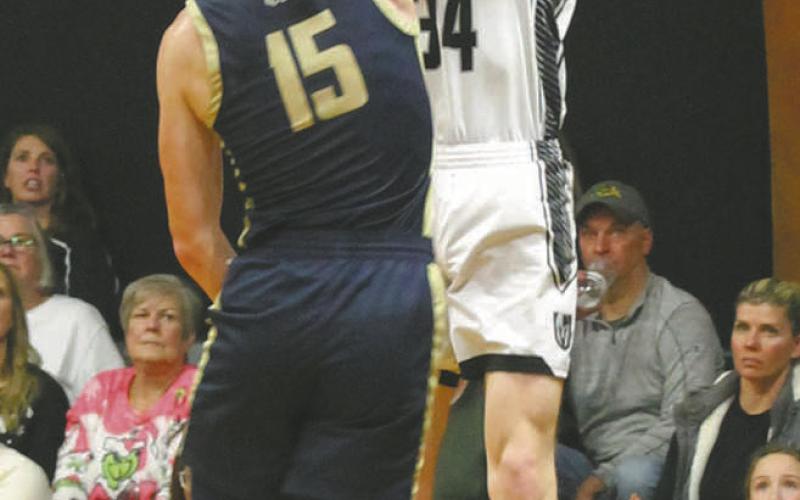 Facing of against North Border defender Garret Willits, DVE's Jack Langerud goes for the shot. Phot by Jamie Rarick