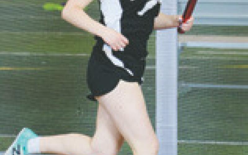 Greta Burrell ran one leg of the girls 4 by 800 relay. Photo by Lyle Van Camp.