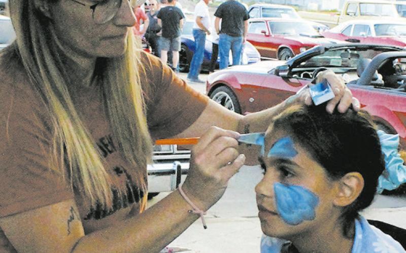 Ciera Dalzell got her face painted by Leanna Lindegard during Thursday's Riverfest events. Photo by Jamie Rarick