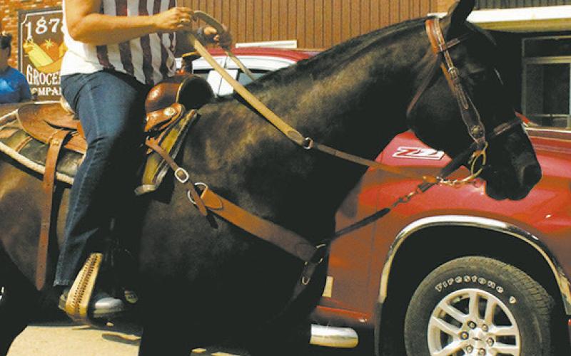 Genafay Pokrzywinski rode down Main Street during Saturday's Riverfest parade. Photo by Jamie Rarick