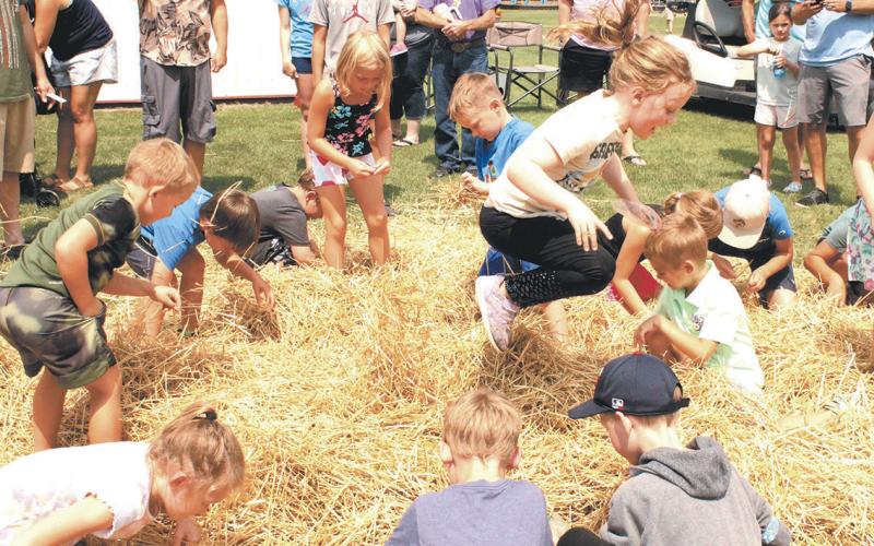 Kids had a blast searching through piles of hay for treasure during Koda Bank's coin scramble, held Saturday at Schumacher Park. Photo by Jamie Rarick