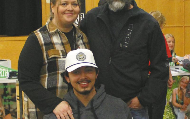 Juan Nevarro, with his parents representing the Army National Guard at Senior Signing Day at DPS. Photo by Andrea Johnston
