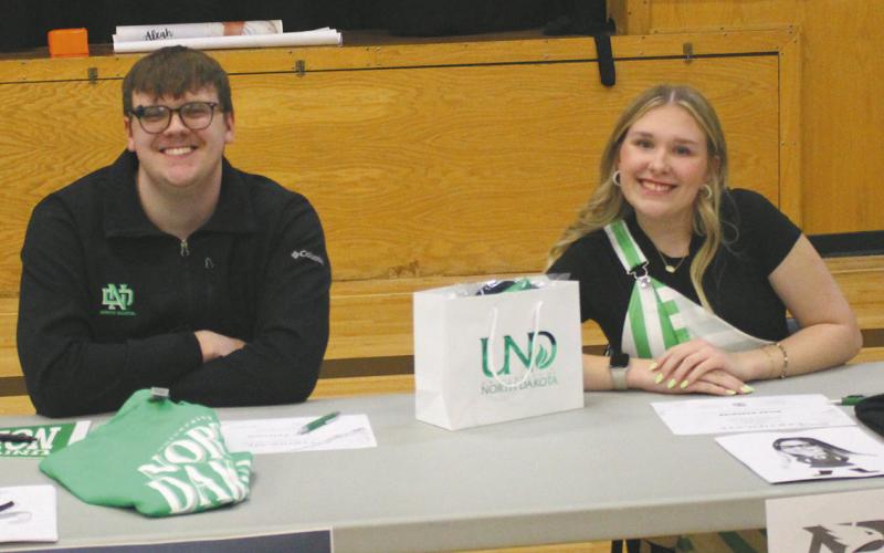 Ian Peterson (left) and Rylee Maurstad (right) at the table that represented student’s heading to UND this fall. Photo by Andrea Johnston