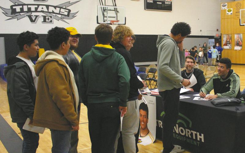 Seniors were available after the speeches to sign autographs for fellow students and attendees. At Daniel De Sousa’s table, students were lined up. Photo by Andrea Johnston