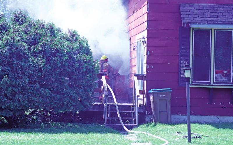 Drayton Volunteer Fire Department works in blistering heat to battle a house fire on Third Street last Friday afternoon.