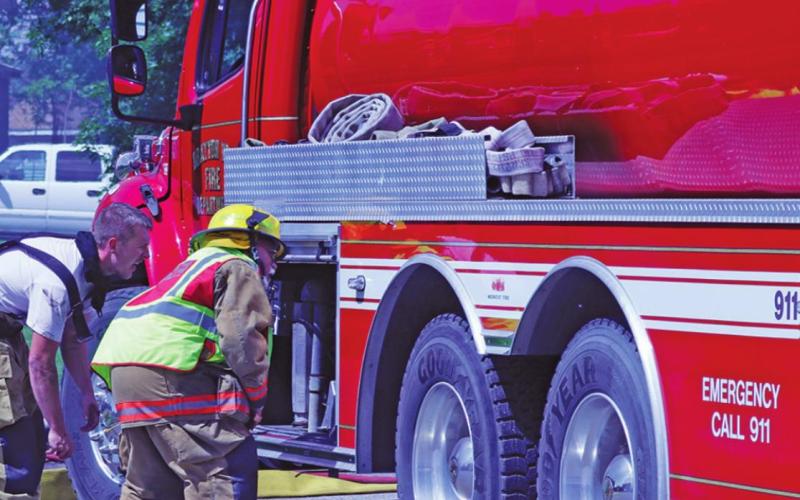 Drayton Volunteer Firemen Grant Schumacher and Bob Merrill check out the water supply at one of the fire trucks. VNV Photo by Lesa Van Camp