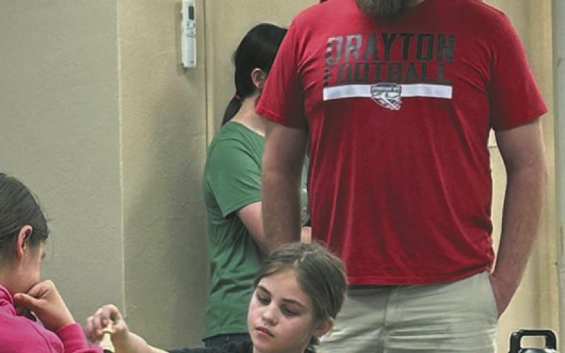 Mr. Foster watches on as Natalie Helm chooses her moves wisely.