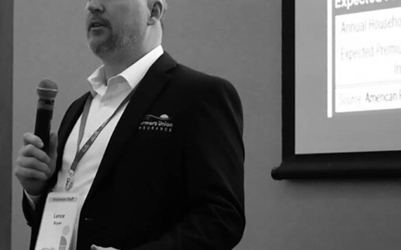 Lance Boyer, sales director of financial products for the North Dakota Farmers Union, talks about expiring Affordable Care Act premium tax credits during the annual meeting of the North Dakota Farmers Union on Dec. 12, 2025. (Photo by Michael Achterling/North Dakota Monitor)