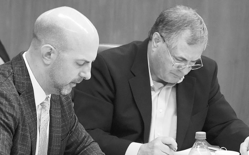 Justin Kringstad, executive director of the North Dakota Pipeline Authority, and Agriculture Commissioner Doug Goehring listen to discussion about two pipeline project proposals during the Aug. 21, 2025, meeting of the North Dakota Industrial Commission. Photo by Mary Steurer/North Dakota Monitor