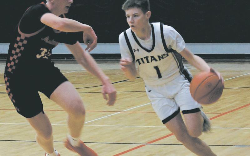 Mustang defender Marek Osowski guards Titan Drew Passa as he moves the ball down the Drayton court Feb. 6. Photo by Jamie Rarick