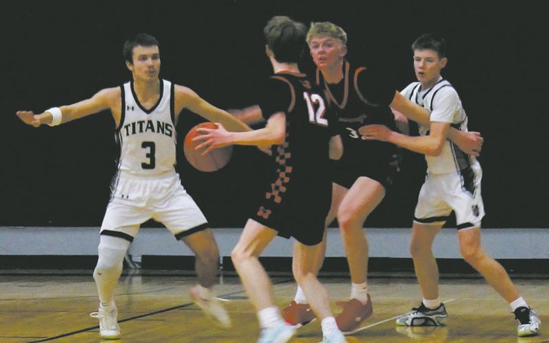 Titan defenders Trenten Bronson-Keena and Drew Passa work to stop the Mustang's play in Drayton Feb. 6. Photo by Jamie Rarick