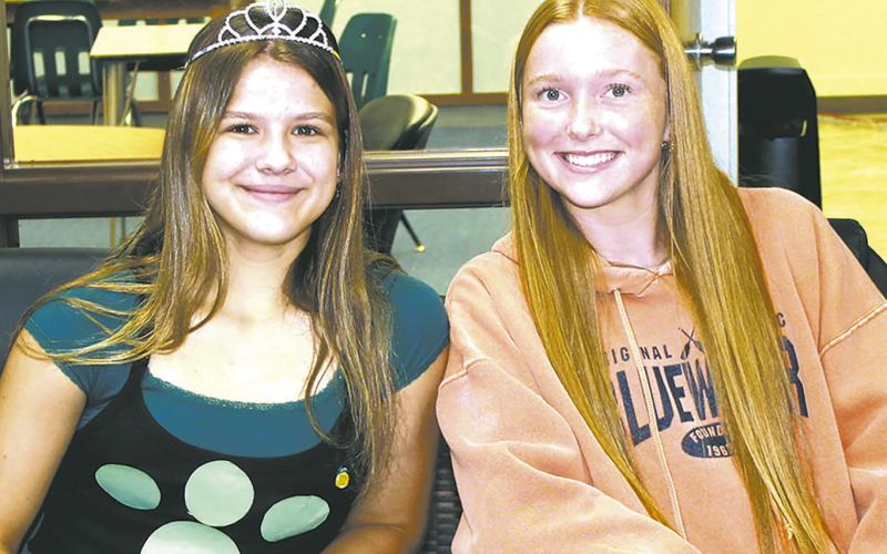 Representing the sophomore class, Violet Hoyles and Peyton Larson volunteered at the check-in table for Wednesday's blood drive at the school. Photo by Jamie Rarick.